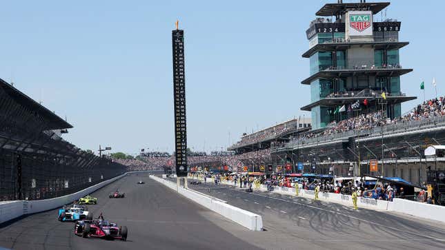 A photo of race cars on the pit straight at the Indy 500 event. 