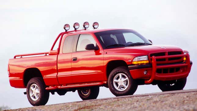 A photo of a red Dodge Dakota pickup truck from the 1990s. 