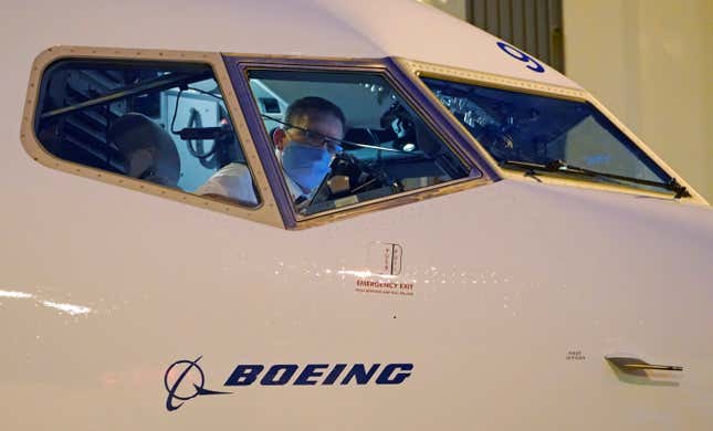 Capt. Brian Eyre, who was serving as first officer, goes through pre-flight preparations in the flight deck before the first Alaska Airlines passenger flight on a Boeing 737-9 Max airplane, Monday, March 1, 2021, prior to a flight to San Diego from Seattle-Tacoma International Airport in Seattle.