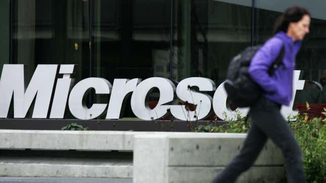 A woman rushes by Microsoft headquarters.
