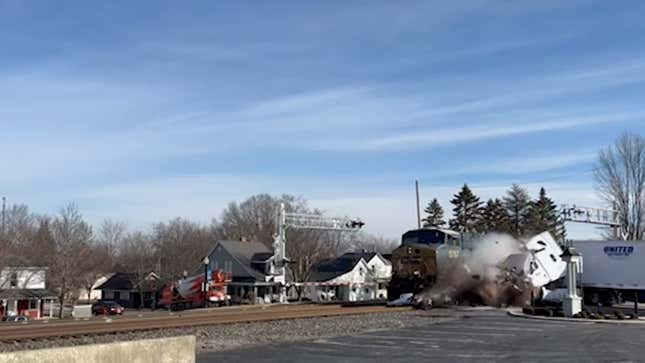 A screenshot of the moment a freight train hits a semi truck. 