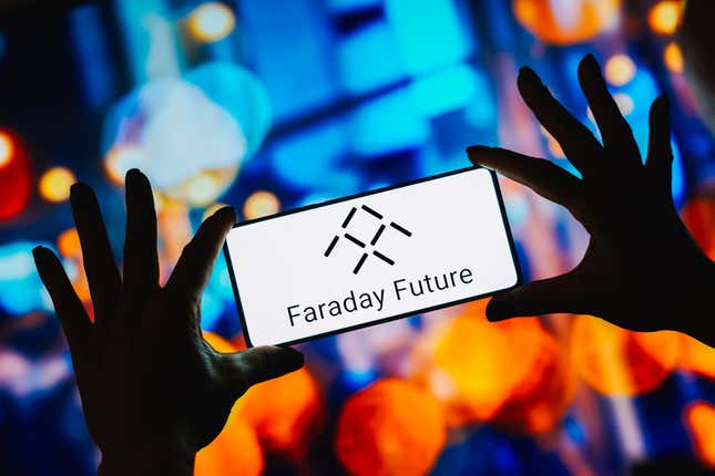 n this photo illustration, the Faraday Future logo is displayed on a smartphone screen
