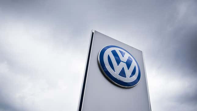 A photo of a VW sign outside a car dealer. 