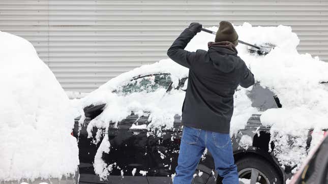 Clearing snow off a car