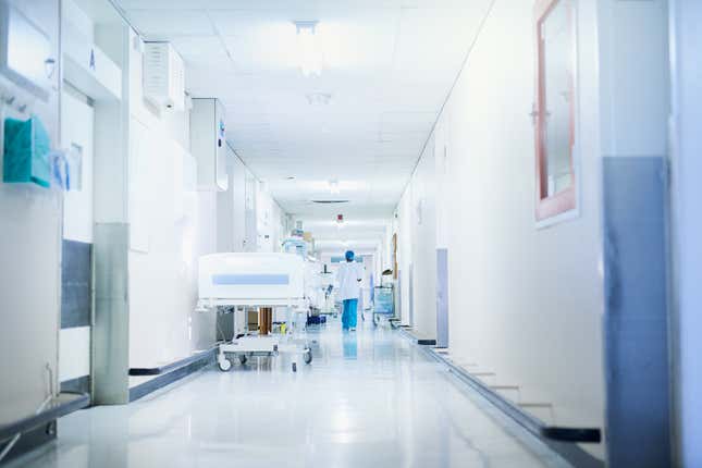 Rearview shot of a surgeon walking down a hospital corridor.