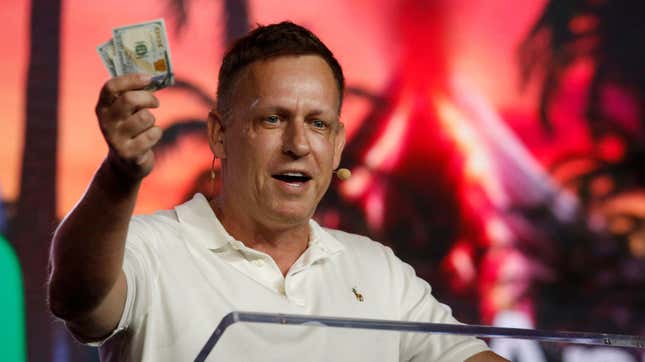 Peter Thiel, co-founder of PayPal, Palantir Technologies, and Founders  Fund, as he holds hundred dollar bills during the Bitcoin 2022  Conference in Miami.
