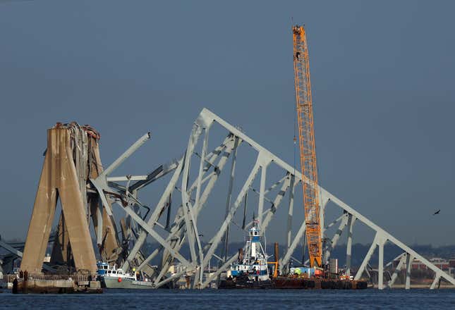A crane works on the debris of the Francis Scott Key Bridge on March 29, 2024 in Baltimore, Maryland.