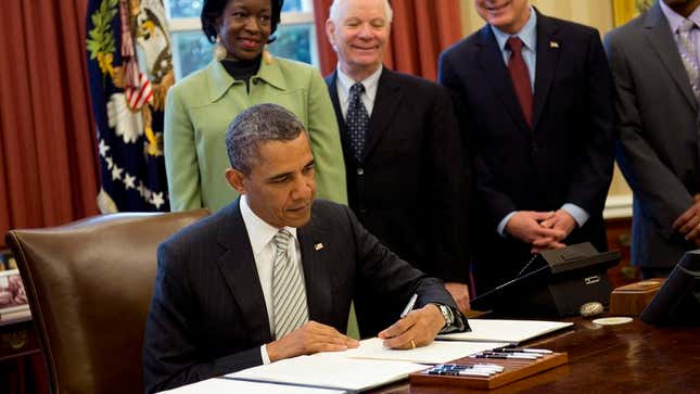 Image for article titled Obama Always Freaked Out By People Standing Above Him Smiling Whenever He Signs Bill