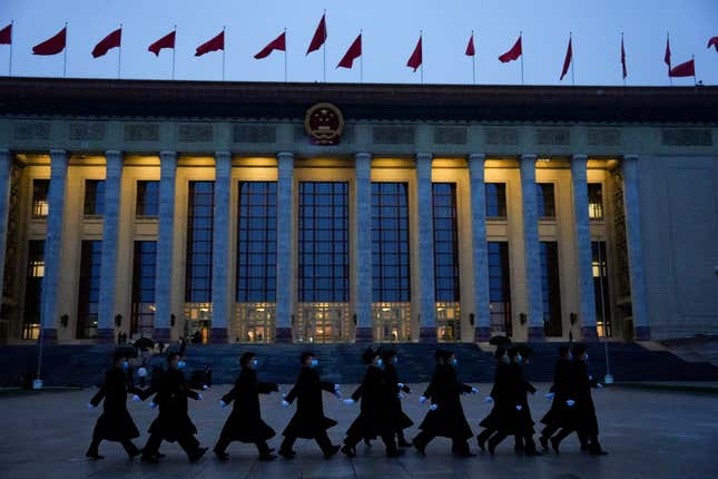 Security personnel march in front of the Great Hall of the People in Beijing, China, Tuesday, March 5, 2024. (AP Photo/Ng Han Guan)