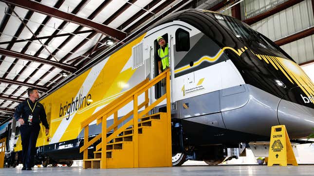 Workers prepare an All Aboard Florida Brightline express inter-city train for display before the start of a media tour in West Palm Beach, Florida, U.S., on Wednesday, Jan. 11, 2017. The Brightline Express project is a $1.5 billion investment that will bring high speed train travel to commuters from Orlando to Miami. 