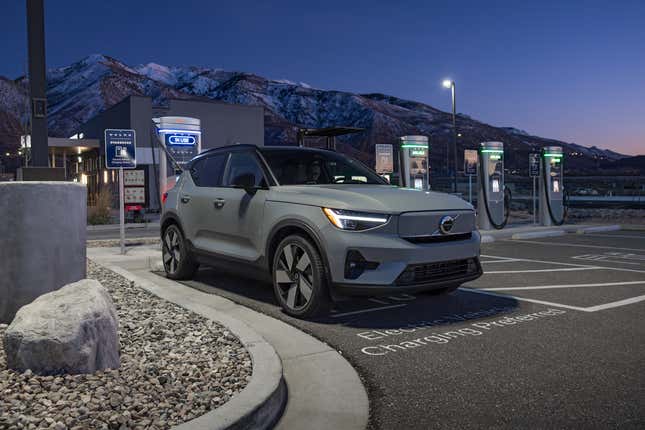 A green Volvo XC40 Recharge plugged into an EV charger