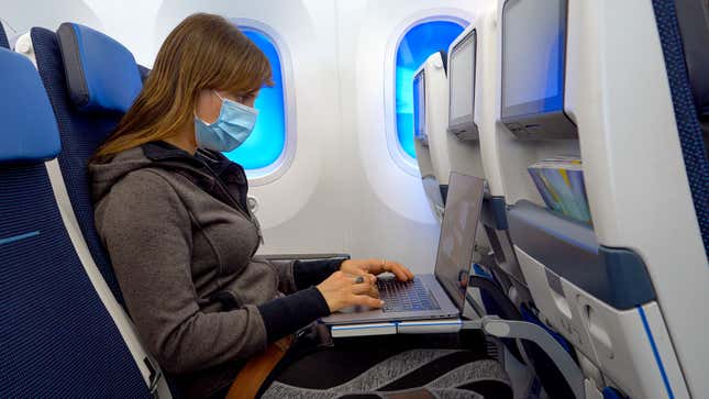 Image for article titled Woman Still Wearing Mask On Plane Must Have Inside Information About Next Pandemic