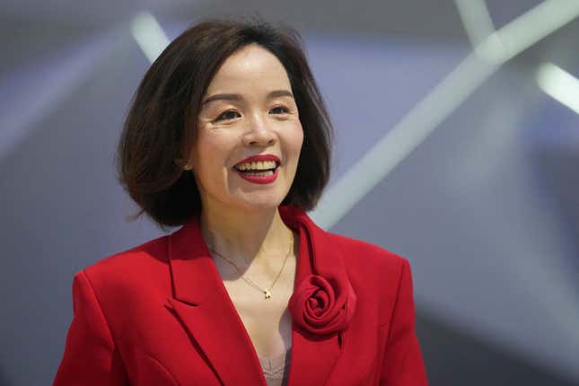 Vu Dang Yen Hang, chief executive officer of VinFast Thailand, smiles in front of its electric vehicle &quot;VF7&quot; during the 45th Bangkok Motor Show in Nonthaburi, Thailand, Tuesday, March 26, 2024. (AP Photo/Sakchai Lalit)