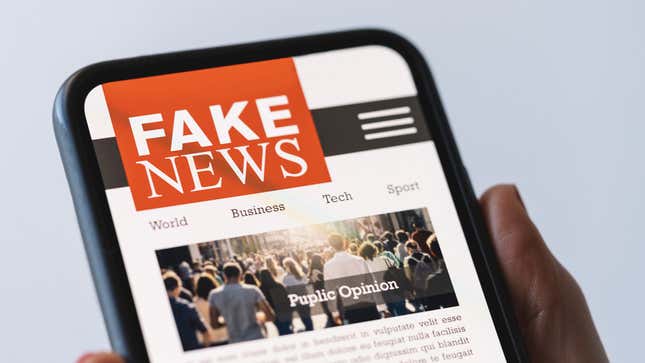 A phone displays a website titled "Fake News."