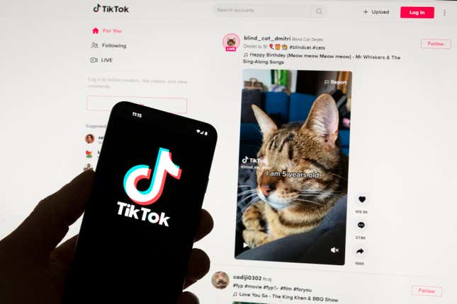 FILE - The TikTok logo is seen on a mobile phone in front of a computer screen which displays the TikTok home screen, Saturday, March 18, 2023, in Boston. European Union regulators said Wednesday, April 17, 2024, they&#39;re seeking details from TikTok on a new app from the video sharing platform that pays users to watch videos. (AP Photo/Michael Dwyer, File)