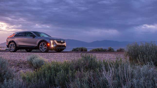 A photo of a silver Cadillac Lyriq in the desert. 