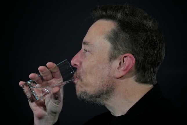 Elon Musk drinks during an in-conversation event with Britain’s Prime Minister Rishi Sunak in London, Thursday, Nov. 2, 2023. 