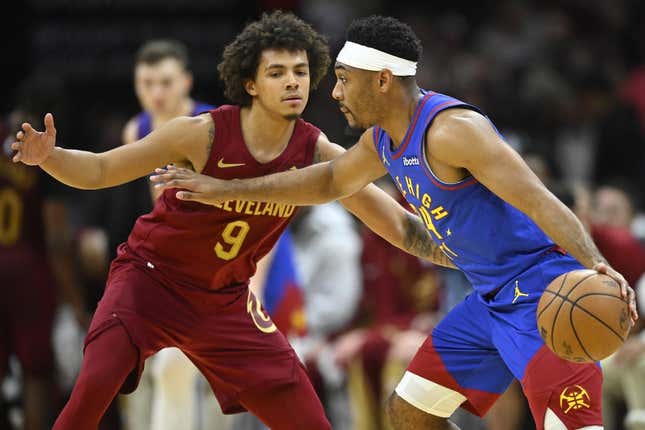 Nov 19, 2023; Cleveland, Ohio, USA; Denver Nuggets guard Jalen Pickett (24) drives against Cleveland Cavaliers guard Craig Porter (9) in the fourth quarter at Rocket Mortgage FieldHouse.