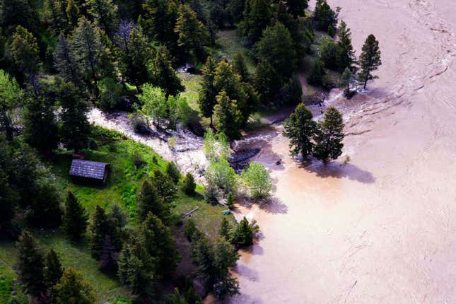 This aerial photo provided by the National Park Service shows the Lower  Blacktail Patrol Cabin washed away in Yellowstone National Park on  Monday, June 13, 2022. 