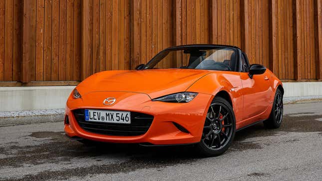 A photo of an orange Mazda Miata sports car. 