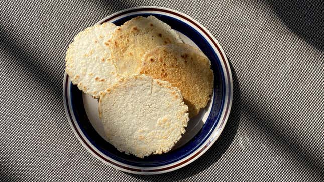 Four homemade tortillas on a plate