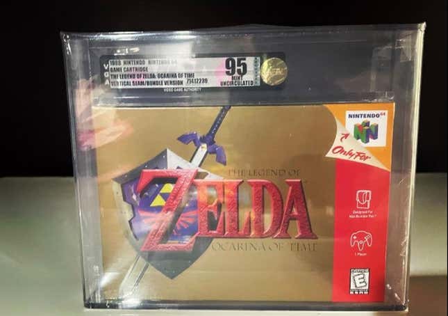 A sealed copy of The Legend of Zelda: Ocarina of Time sits on a table. 