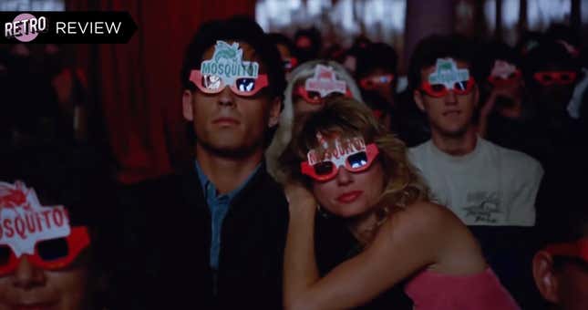A man and a woman sit in a movie theater wearing colorful 3D glasses that say "Mosquito" on them.