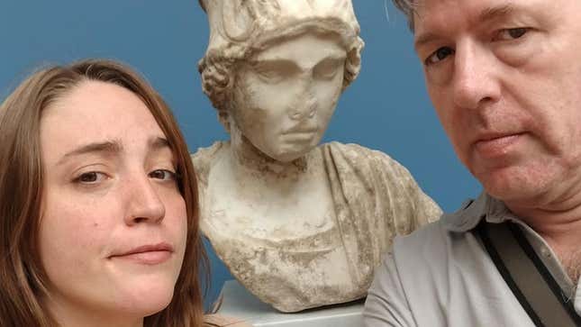 Julian LeFay and his daughter Shae, stood either side of a marble bust.