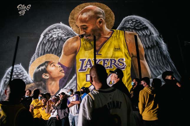 Lakers fans stand in line to celebrate in front of a mural of Kobe Bryant and his daughter Gianna Bryant on October 11, 2020, in Los Angeles, California.