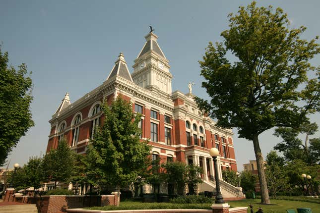 exterior view of a brick courthouse with trees around it