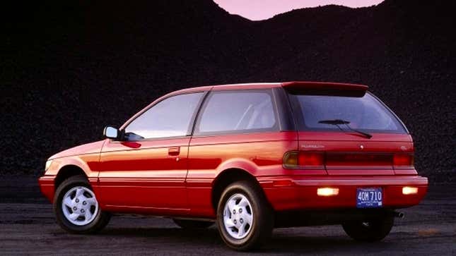 A photo of a red Plymouth Colt hatchback. 