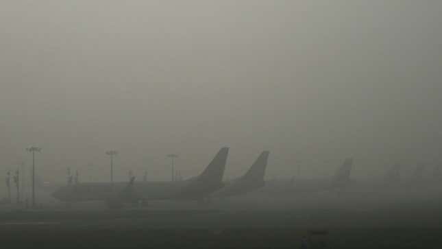 A photo of planes disappearing into the fog at Delhi airport. 