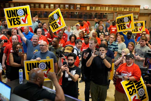 Volkswagen automobile plant employees celebrate winning a vote to join the UAW union Friday, April 19, 2024, in Chattanooga, Tenn. (AP Photo/George Walker IV)