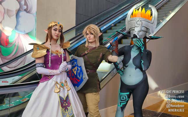 Twilight Princess cosplayers stand near an escalator.