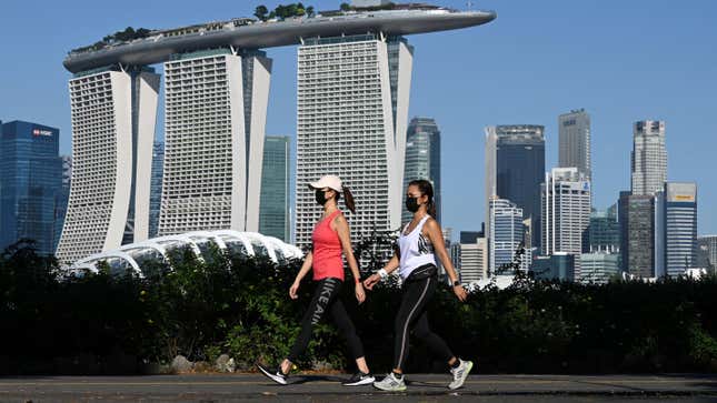 People make their way along the park connector at Marina Bay East in Singapore on August 9, 2021.