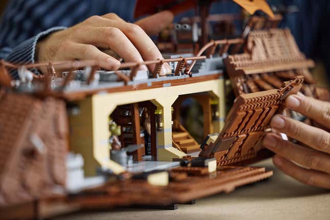 A guy plays with the Lego barge