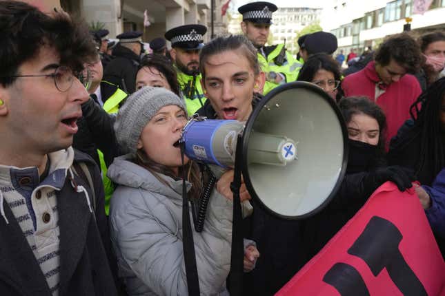 Environmental activist Greta Thunberg shouts slogans during the Oily Money Out protest outside the Intercontinental Hotel, in London, Tuesday, Oct. 17, 2023. Greta Thunberg was detained by British police on Tuesday alongside other climate activists who gathered outside a central London hotel to disrupt a meeting of oil and gas company executives. (AP Photo/Kin Cheung)