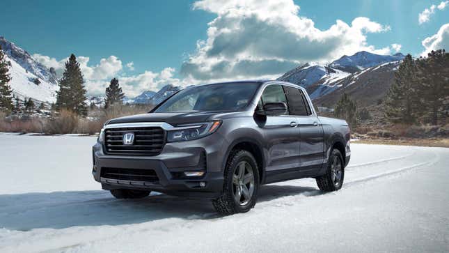 A grey Honda Ridgeland driving across snow