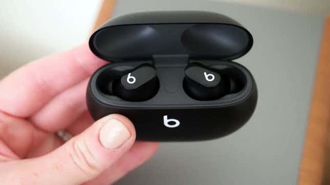 A photo of a person holding the Beats Studio Buds.