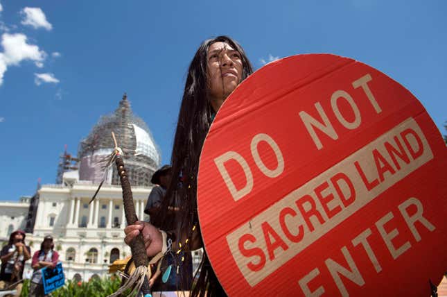 FILE - An Apache activist dancer performs in a rally to save Oak Flat, land near Superior, Ariz., sacred to Western Apache tribes, in front of the U.S. Capitol in Washington, Tuesday, July 22, 2015. An Apache group that has fought to protect land it considers sacred from a copper mining project in central Arizona suffered a significant blow Friday, March 1, 2024, when a divided federal court panel voted 6-5 to uphold a lower court&#39;s denial of a preliminary injunction to halt transfer of land for the project. (AP Photo/Molly Riley, File)