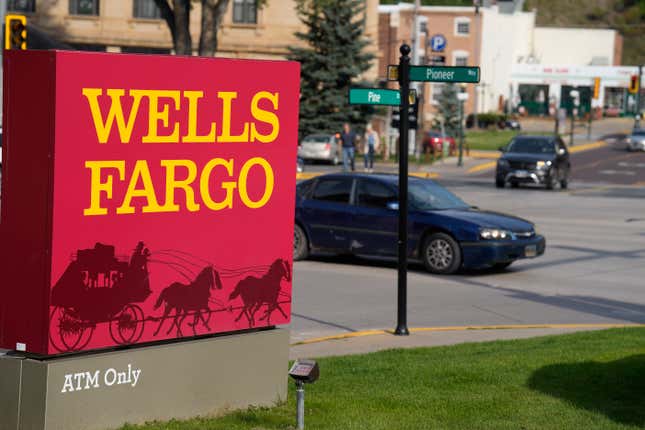 Motorists drive past a sign outside a branch of Wells Fargo bank, Wednesday, Sept. 20, 2023, in Deadwood, S.D. The Biden Administration is easing its restrictions on banking giant Wells Fargo, saying the bank has sufficiently fixed its toxic culture after years of scandals. The news sent Wells Fargo&#39;s stock up sharply in afternoon trading as investors speculated that the bank, which has been kept under a tight leash by regulators for years, may be able to start growing again. (AP Photo/David Zalubowski, File)