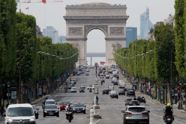 FILE - Cars drive on the Champs Elysee avenue, Thursday, May 7, 2020 in Paris. Paris mayor says her city has too many SUVs, so she’s asking voters to decide on parking fee hike on Feb. 4, 2024. The Arc de Triomphe is seen in background. (AP Photo/Christophe Ena, File)