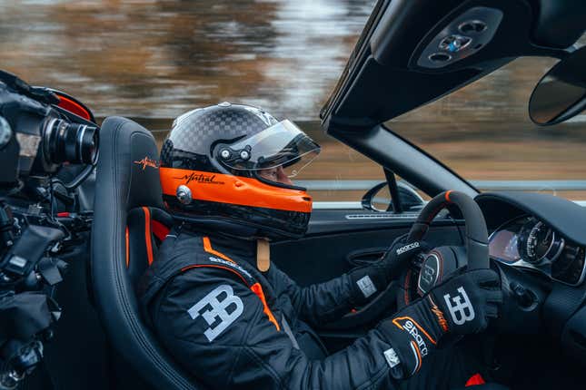 Andy Wallace driving the black and orange Bugatti W16 Mistral World Record Car