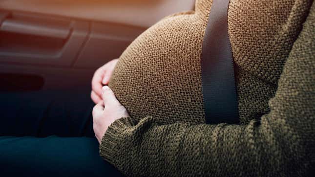 Pregnant woman wearing seat belt.
