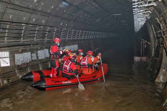 This photo taken on July 26, 2021 shows rescuers searching inside the  subway which was flooded following heavy rains in Zhengzhou, in China’s  central Henan province. 