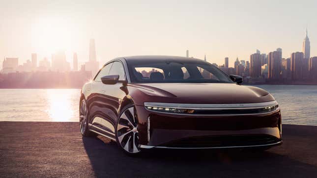 A photo of a purple Lucid Air with the New York skyline behind. 