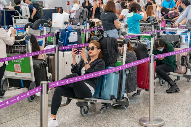 Travelers queue up at the check-in counters of the Hong Kong International Airport on July 19, 2024 in Hong Kong, China 