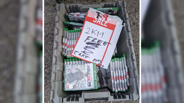 An image shows a bin filled with sealed copies of NBA 2K19.