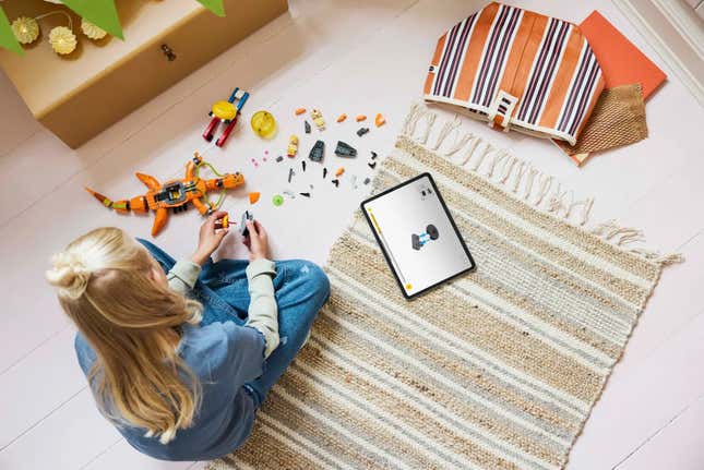 An overhead shot of a kid building the Legos.