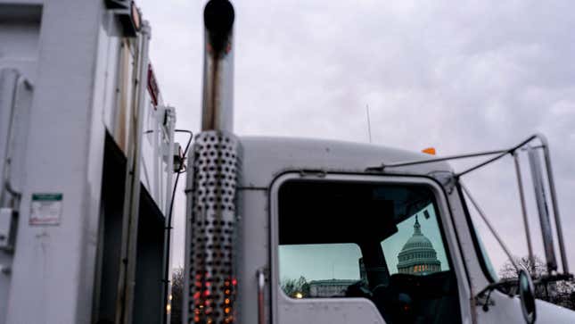 Trucks block a street near the US Capitol in Washington, DC, on February 23, 2022, as authorities prepare for the first of three possible truck convoys. - National Guard troops have been approved to help local authorities handle an expected convoy of trucks headed to Washington, DC, to protest Covid-19 vaccine mandates, inspired by the Canadian trucker protest. 
